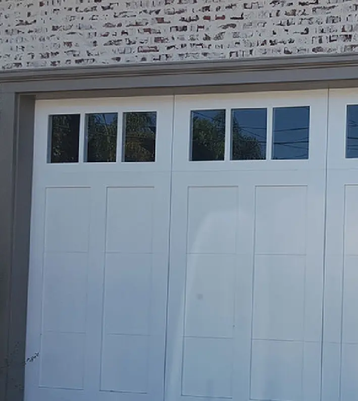 A white garage door with windows on the side.