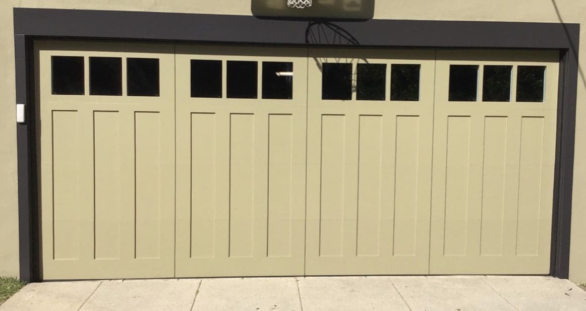 A tan garage door with windows on the side.