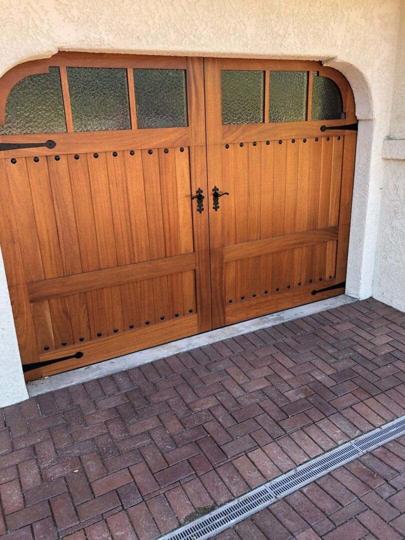 A wooden garage door with two sets of windows.