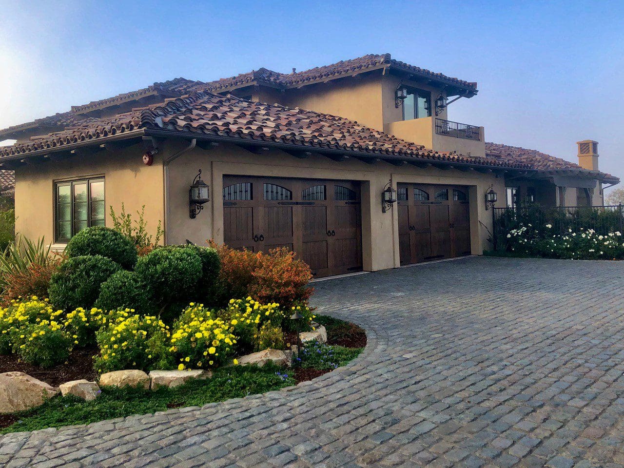 A large driveway with two cars in it