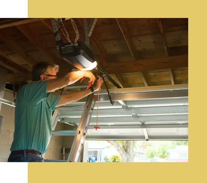 A man is working on the garage door.