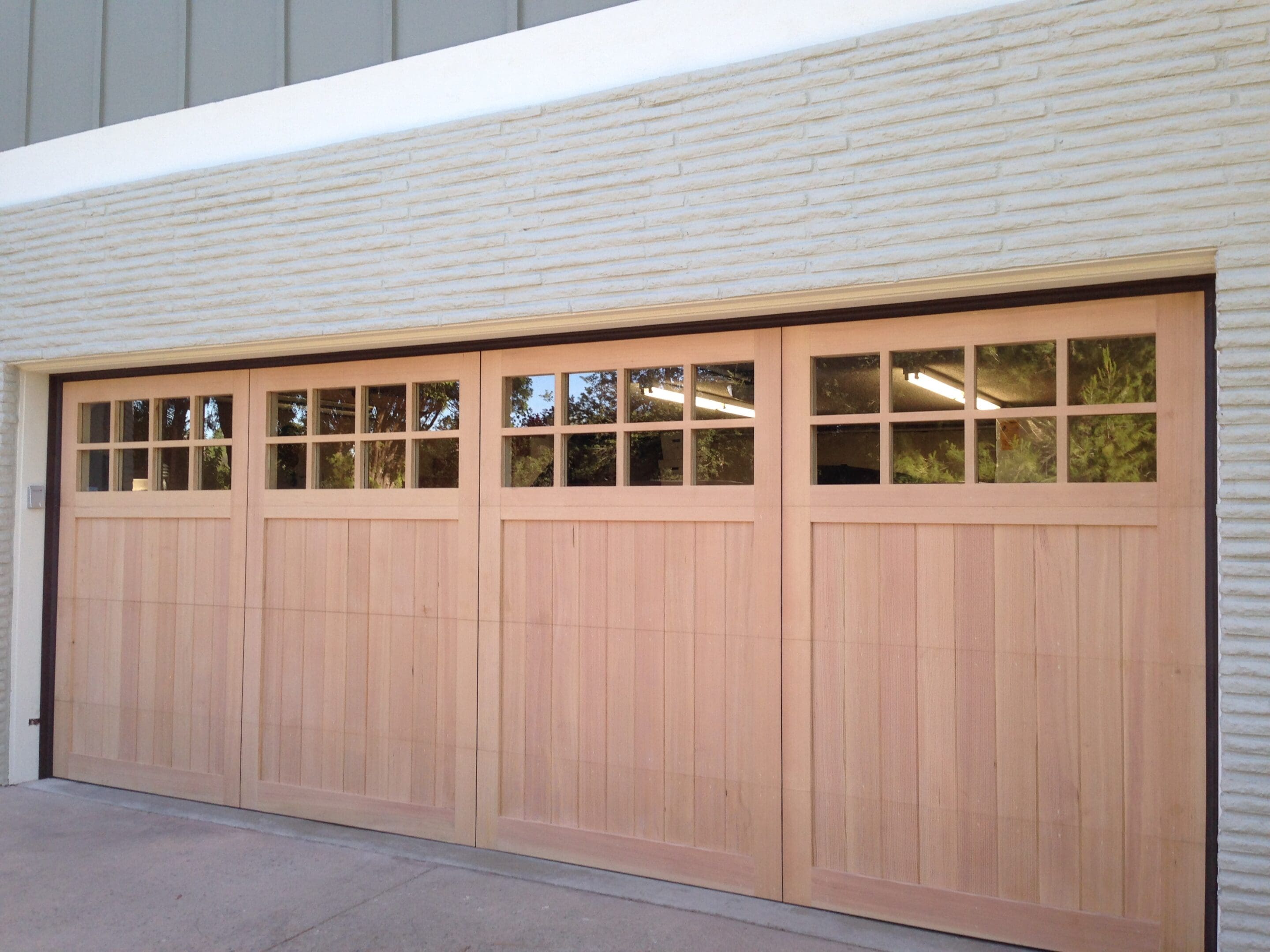 A garage door that is open and has windows.